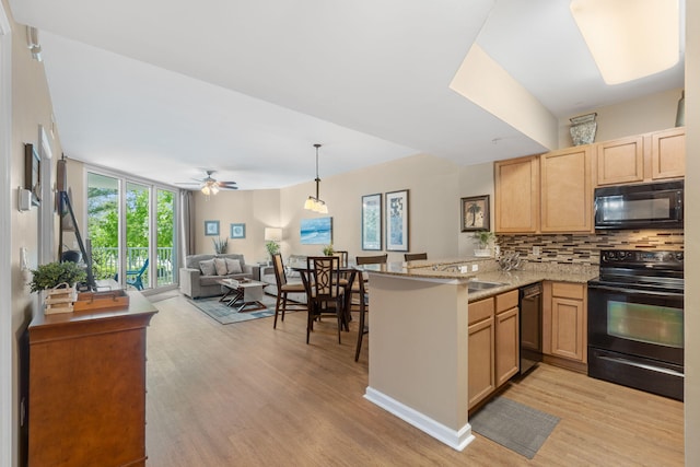 kitchen featuring ceiling fan, kitchen peninsula, light hardwood / wood-style floors, and black appliances