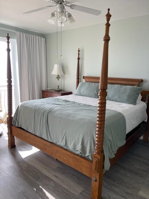 bedroom featuring dark hardwood / wood-style flooring and ceiling fan