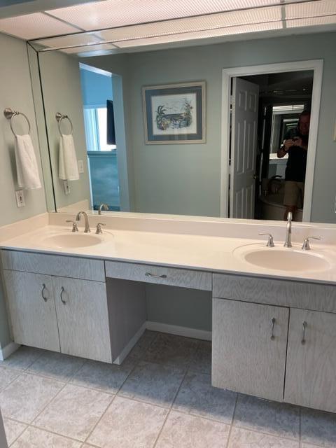 bathroom with tile floors and dual vanity