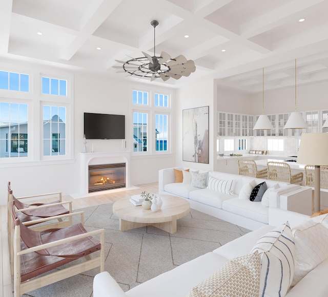 living room featuring beam ceiling, a towering ceiling, coffered ceiling, light hardwood / wood-style floors, and ceiling fan