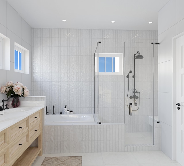 bathroom featuring tile walls, vanity, tile floors, and separate shower and tub