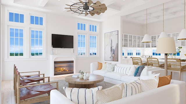 living room featuring beam ceiling, a towering ceiling, and hardwood / wood-style flooring