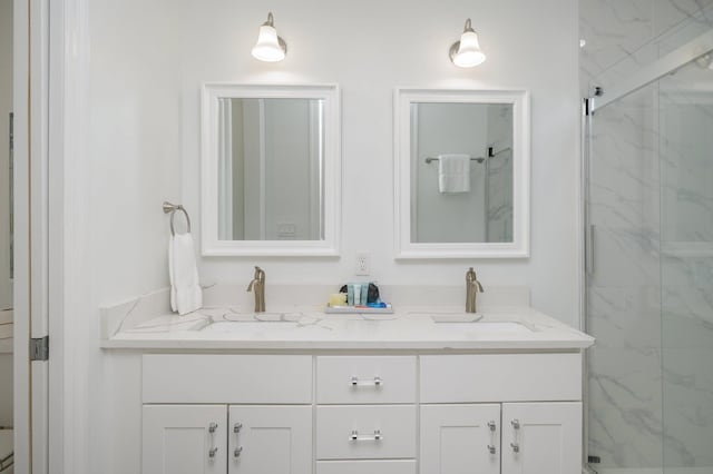 bathroom with dual bowl vanity and an enclosed shower