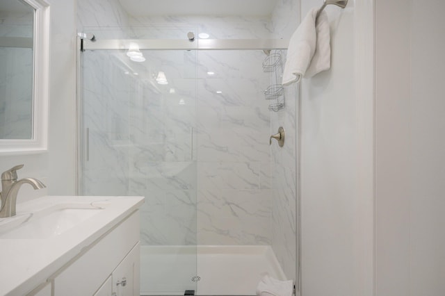 bathroom featuring walk in shower and large vanity