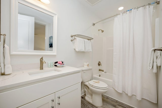 full bathroom with wood-type flooring, shower / bath combo, vanity, and toilet