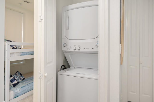 clothes washing area with stacked washer / drying machine