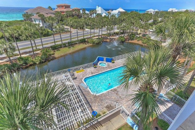 view of swimming pool featuring a water view