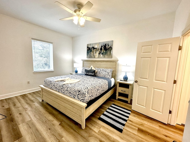 bedroom with light hardwood / wood-style floors and ceiling fan