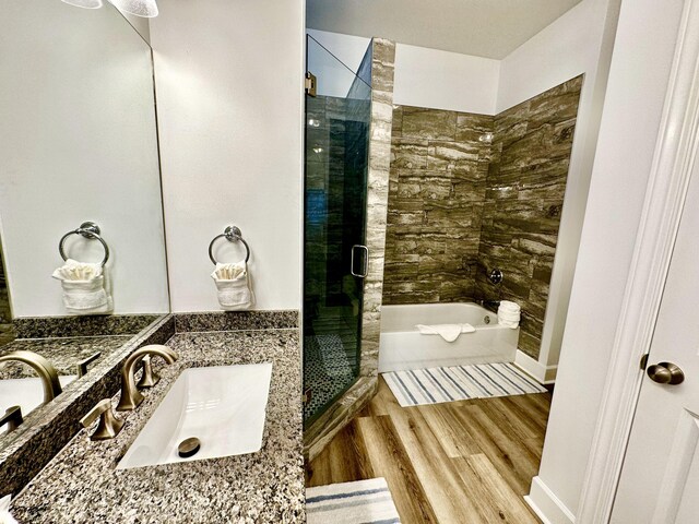 bathroom with wood-type flooring, vanity, and separate shower and tub