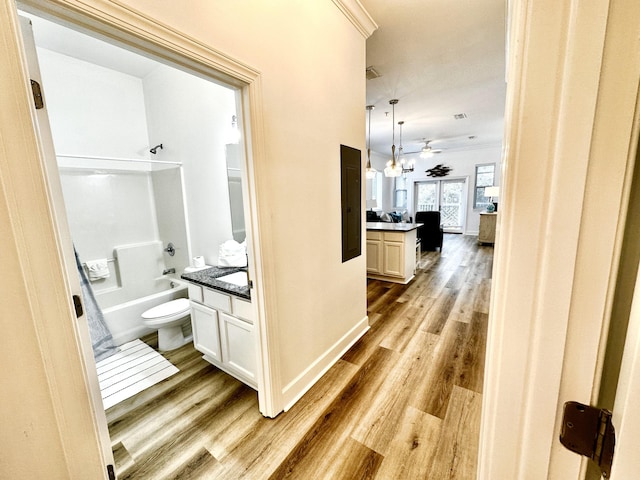 hallway with light hardwood / wood-style floors