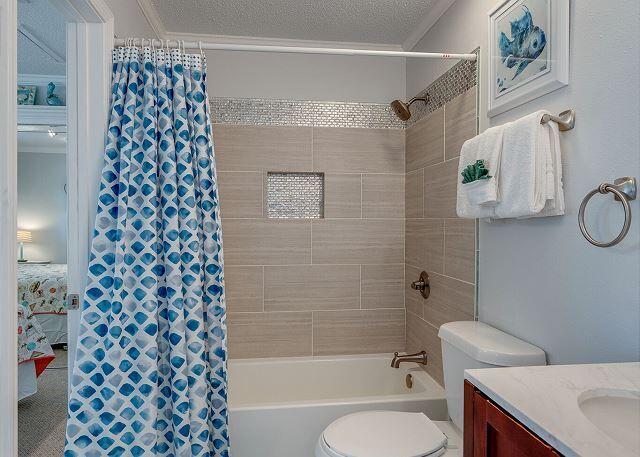 full bathroom featuring toilet, shower / bath combo with shower curtain, a textured ceiling, vanity, and ornamental molding