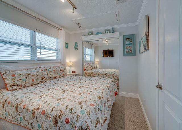 carpeted bedroom featuring a textured ceiling and track lighting