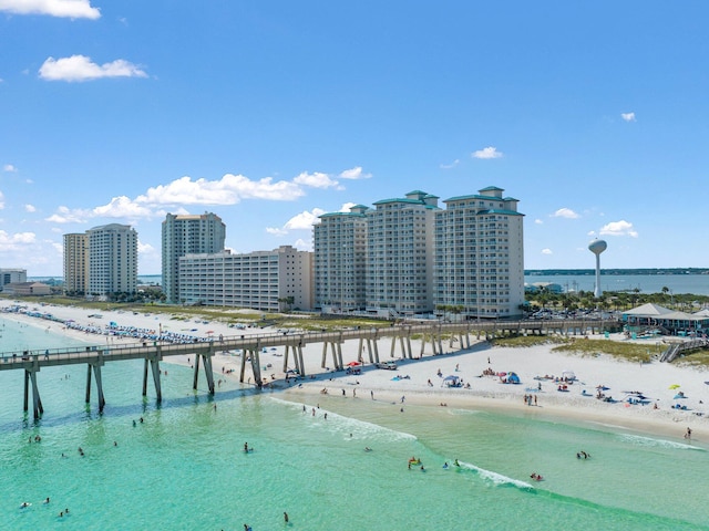 drone / aerial view featuring a water view and a beach view