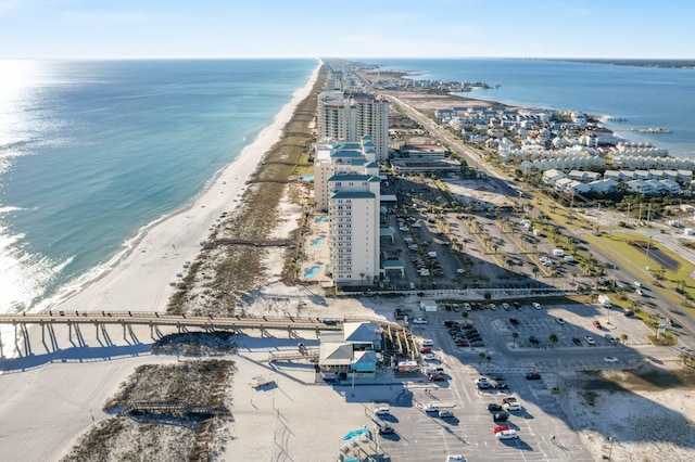 drone / aerial view with a water view and a beach view