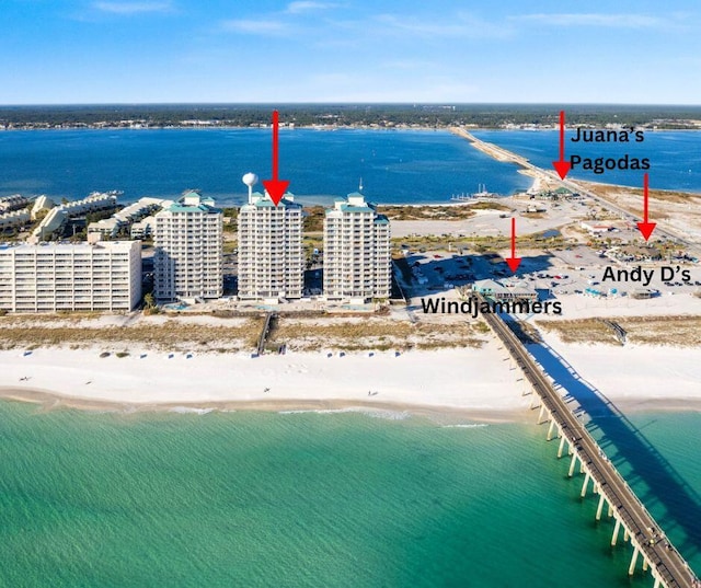 drone / aerial view with a beach view and a water view