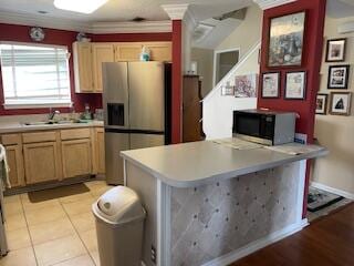 kitchen featuring sink, stainless steel fridge with ice dispenser, light brown cabinets, and light tile floors