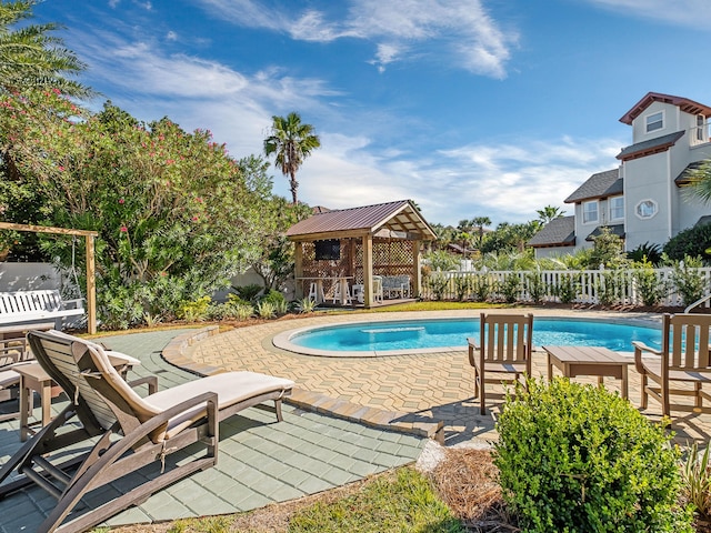 view of swimming pool with a patio and a gazebo