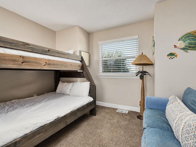 bedroom with dark colored carpet