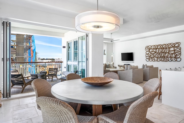 dining area featuring ceiling fan and light tile floors