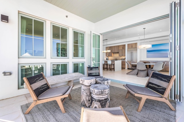 sunroom / solarium featuring an inviting chandelier