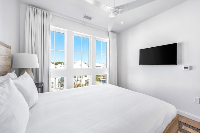 bedroom with wood-type flooring and ceiling fan