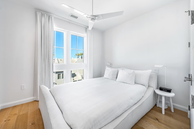 bedroom with light hardwood / wood-style flooring and ceiling fan