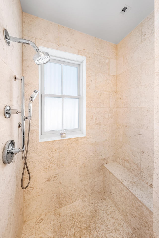 bathroom with a tile shower