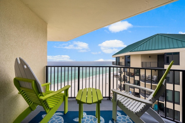 balcony with a view of the beach and a water view