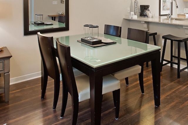 dining room featuring dark hardwood / wood-style floors and sink