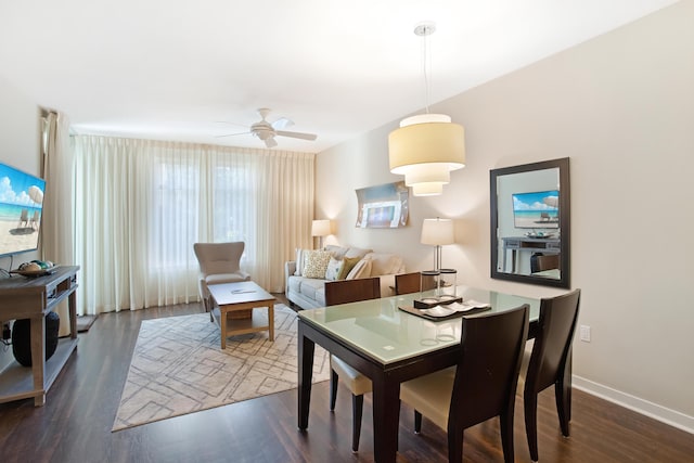 dining space featuring ceiling fan and dark hardwood / wood-style floors