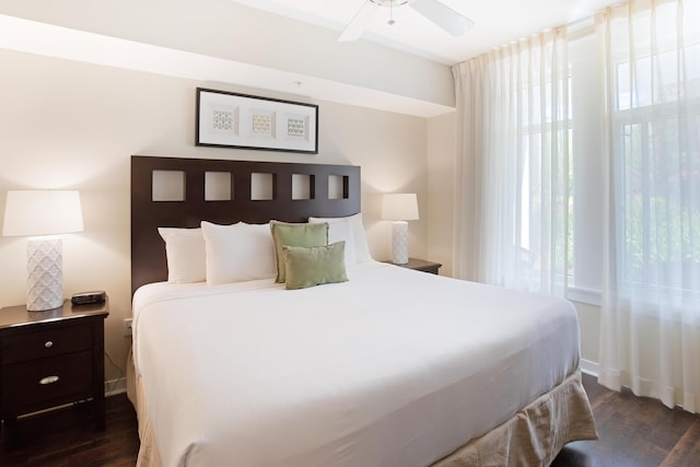 bedroom with ceiling fan and dark wood-type flooring