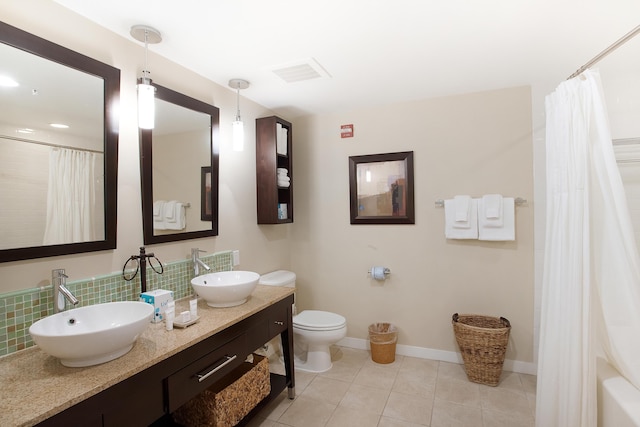 bathroom with toilet, tile floors, and vanity