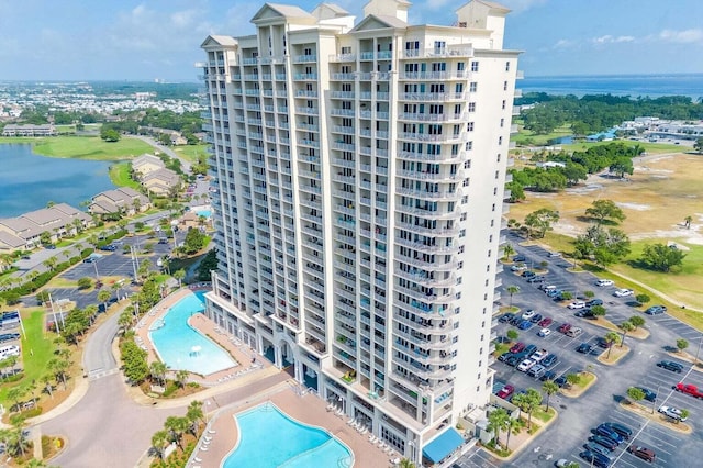 view of property with a water view and a community pool