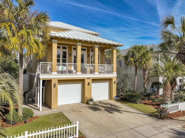 view of front of property featuring a balcony and a garage