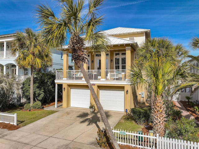 coastal inspired home featuring a garage and a balcony