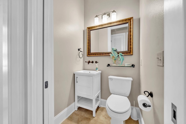 bathroom with tile patterned floors, vanity, and toilet