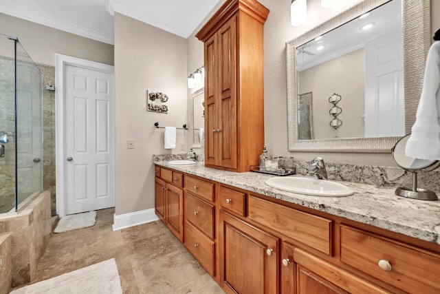 bathroom featuring a tile shower, crown molding, and vanity