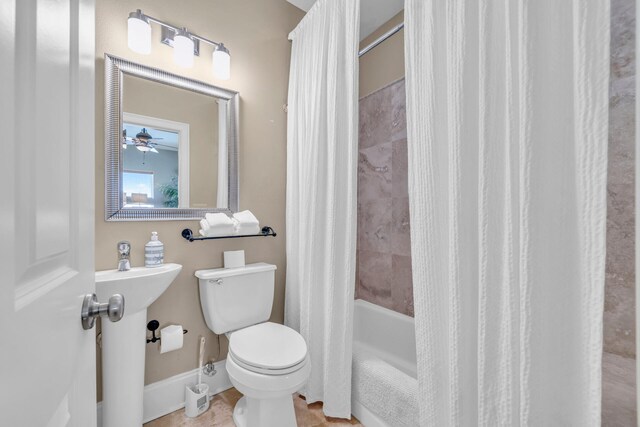 bathroom featuring ceiling fan, shower / tub combo with curtain, and toilet