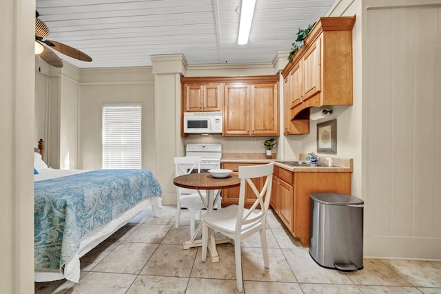 tiled bedroom with ceiling fan, sink, and ornamental molding