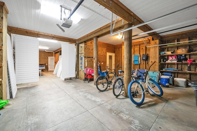 garage featuring wooden walls and a garage door opener