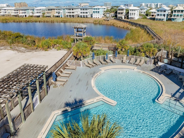 view of swimming pool featuring a water view