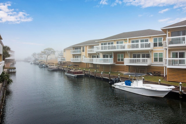 dock area featuring a balcony and a water view