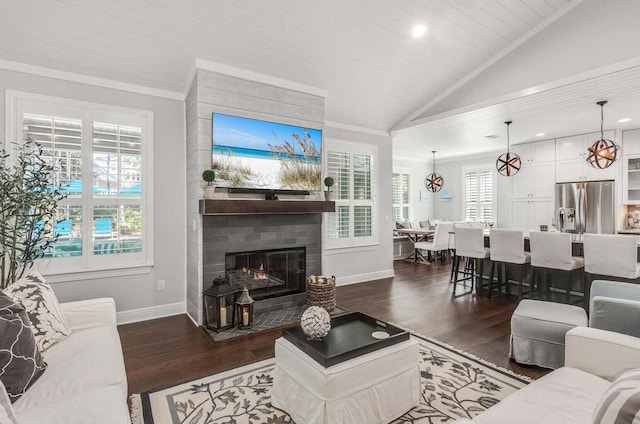 living room featuring a fireplace, dark wood-type flooring, lofted ceiling, and ornamental molding