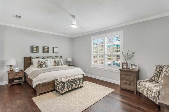 bedroom with ornamental molding, a textured ceiling, ceiling fan, and dark wood-type flooring