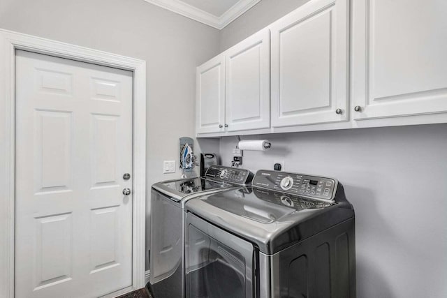 washroom featuring crown molding, hookup for an electric dryer, washing machine and clothes dryer, and cabinets