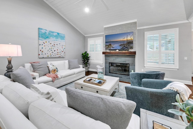 living room featuring wood-type flooring, a fireplace, lofted ceiling, and crown molding