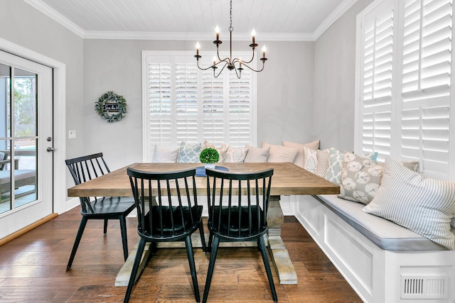 dining room with an inviting chandelier, dark hardwood / wood-style flooring, and crown molding