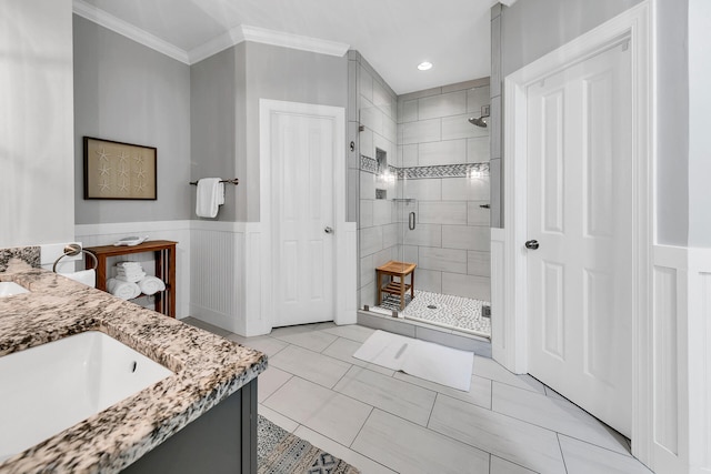 bathroom with walk in shower, crown molding, tile floors, and double sink vanity