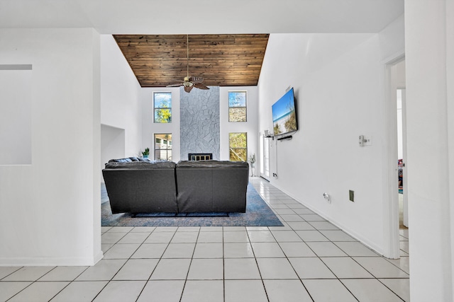 interior space with high vaulted ceiling, ceiling fan, a fireplace, and wood ceiling