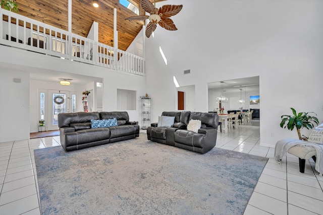 tiled living room featuring wooden ceiling, high vaulted ceiling, and ceiling fan with notable chandelier